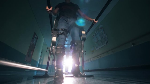 A person walking in a modern device, bottom view.