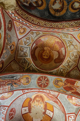 Detail from the fresk of Elmalı Church. Impressive fairy chimneys of sandstone in the canyon near Cavusin village, Cappadocia, Nevsehir Province in the Central Anatolia Region of Turkey.
