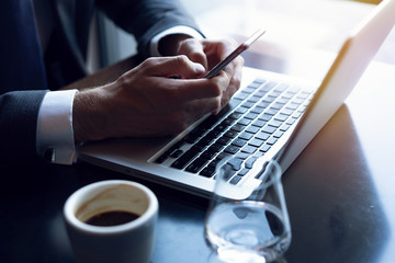 Young businessman working with modern devices, digital tablet computer and mobile phone. New technologies for success workflow concept.