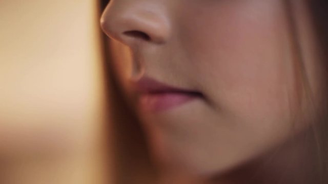 Close up of a girl's lips smile beautiful child baby face kid mouth portrait hair young communication dialogue cute pretty slow motion