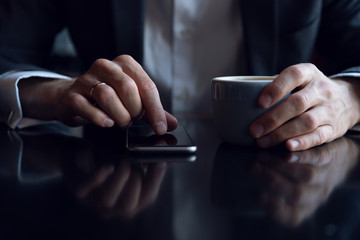 close up of a business man using a mobile phone