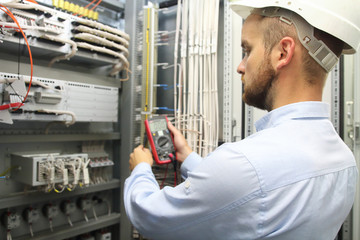 Male engineer are checking electrical system with electronic tools.