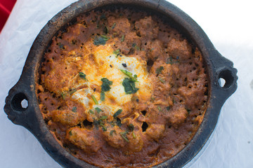 Kefta tajin, tipical moroccan food. Kefta are spicy meatballs slow cooked in tomatoes sauce with egg and parsley on top.