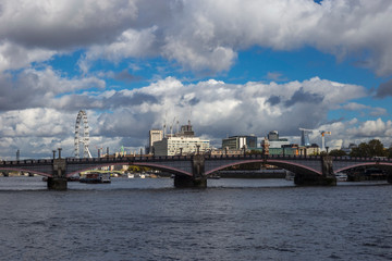 Fototapeta na wymiar London skyline seen from the River Thames on a beautiful cloudy day