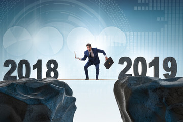 Businessman balancing between 2018 and 2018