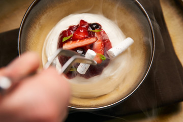 Cook chef making fruit ice cream added liquid nitrogen