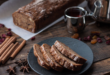 Homemade banana bread with anis star and cinnamon on a dark wooden background