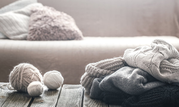Background with knitted sweaters on a wooden background
