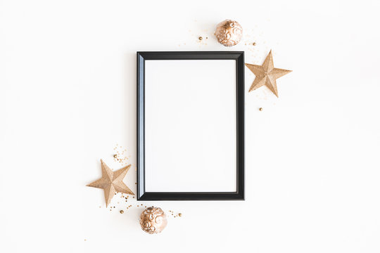Christmas composition. Photo frame, golden decorations on white background. Christmas, winter, new year concept. Flat lay, top view, copy space