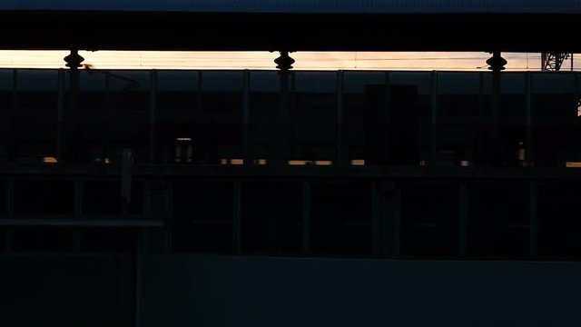 Silhouette Of Subway Train Arriving At The Station, People Leaving The Railway Carriages Walking On The Platform During Sunset. Scene On The Railway Station Station: People Return Home In The Evening