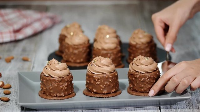 Delicious mini cakes. French cake with caramel and nuts inside.