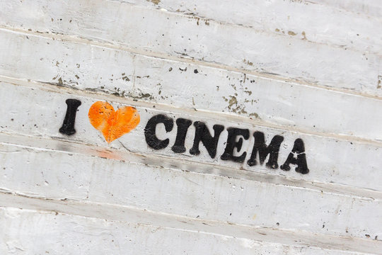 Advertising inscription on the steps of the cinema. The art of cinema. The evolution of filmmaking. Love for good movies. Invitation to the cinema. Box office film. - Powered by Adobe