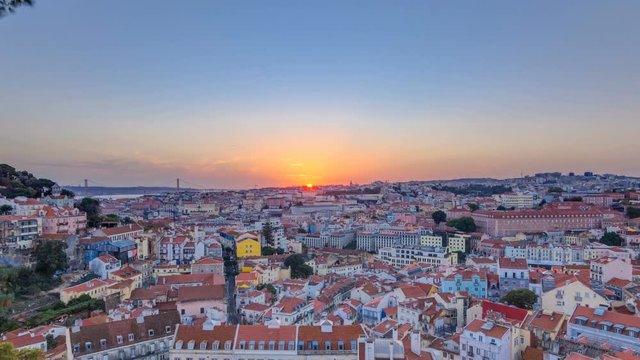 Lisbon at sunset aerial panorama view of city centre with red roofs at Autumn evening timelapse, Portugal
