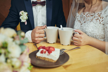 couple drinks coffee with fruit cakes at a cafe