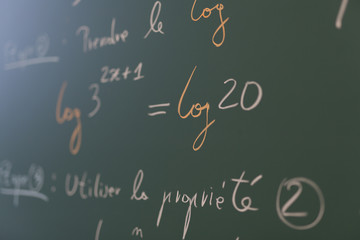 Fototapeta na wymiar Mathematical formulae on a blackboard in a classroom.