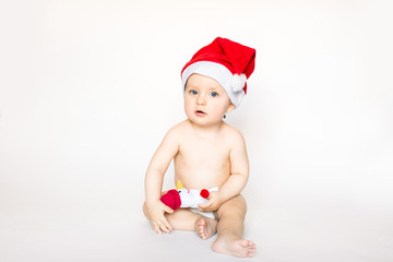 small beautiful girl in New Year's cap and holding a little snowman