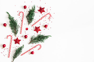 Christmas composition. Red decorations, fir tree branches on white background. Christmas, winter, new year concept. Flat lay, top view, copy space
