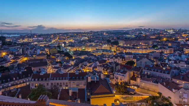 Lisbon after sunset aerial panorama view of city centre with red roofs at Autumn day to night timelapse, Portugal