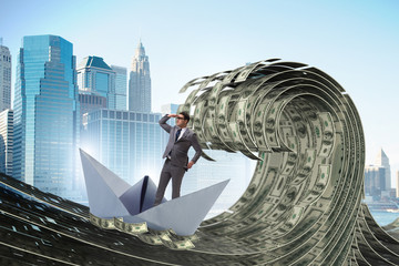 Businessman riding paper boat in dollar sea