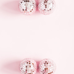 Christmas composition. Frame made of pink disco balls on pastel pink background. Christmas, winter,...