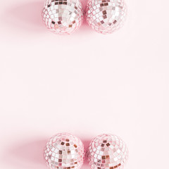 Christmas composition. Frame made of pink disco balls on pastel pink background. Christmas, winter, new year concept. Flat lay, top view, copy space, square