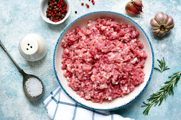 Minced meat in a bowl with spices.Top view with copy space.
