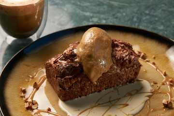 Close up of Chocolate cake with custard and pistachio ice cream