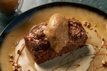Close up of Chocolate cake with custard and pistachio ice cream