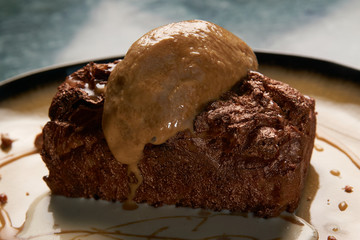 Close up of Chocolate cake with custard and pistachio ice cream