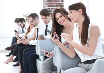 young employees of the company using their gadgets