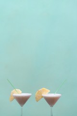 isolated Pineapple Cocktails on green background