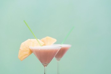 isolated Pineapple Cocktails on green background