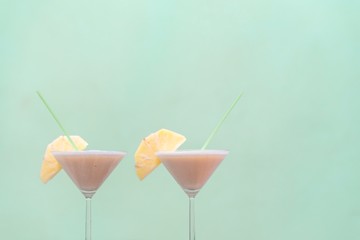 isolated Pineapple Cocktails on green background