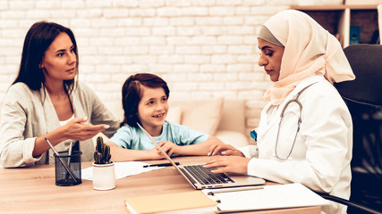 Fototapeta premium Mother with Son at Arabic Doctor's Appointment