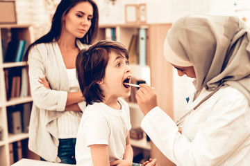 Fototapeta na wymiar Muslim Pediatrician Examining Boy, Throat Sick