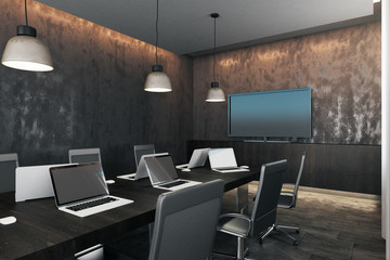 Dark meeting room with device screens