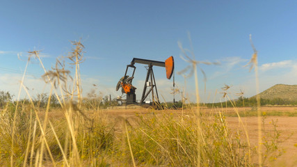 Industrial jack pump platform working on oil field in Texas