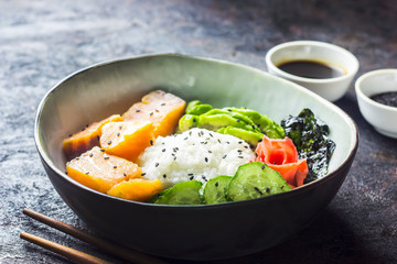 Hawaiian salmon poke bowl with seaweed and avocado