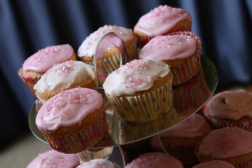 Close up of a display of pink cupcakes.