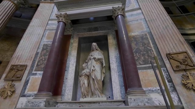 Interior view of the Pantheon in Rome, Italy, featuring a classical statue framed by massive columns and historic architecture. This Rome city landmark showcases ancient Roman heritage, art, and archi