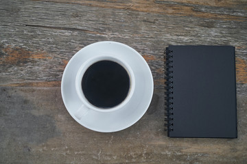 Obraz na płótnie Canvas Black notebook and black coffee