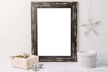 Empty white frame mock up. Black wooden frame mockup with christmas decorations on a white background