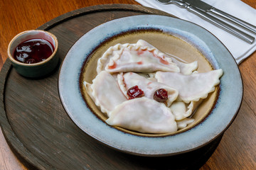 dumplings with cherries on a plate