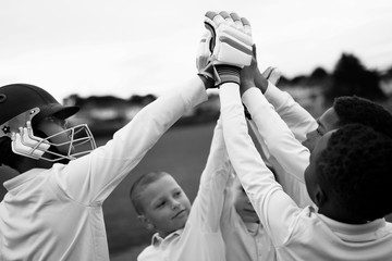 Group of young cricketers doing a high five