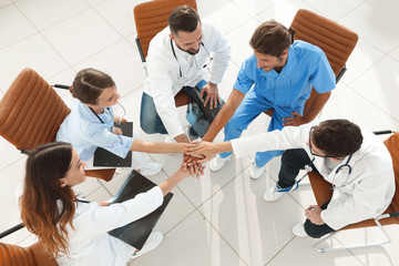 Fototapeta na wymiar medical staff hands clasped together,sitting at a Desk