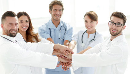 Fototapeta premium Doctors and nurses stacking hands. concept of mutual aid.