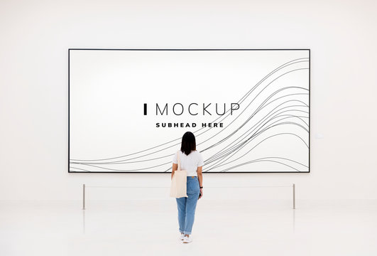 Woman at an exhibition looking at an art piece mockup