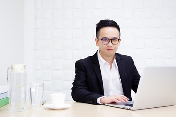 Portrait of young smart business man working in the office close up.