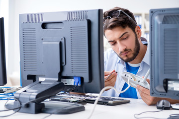 IT technician looking at IT equipment