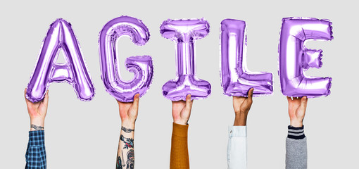 Hands holding agile word in balloon letters
